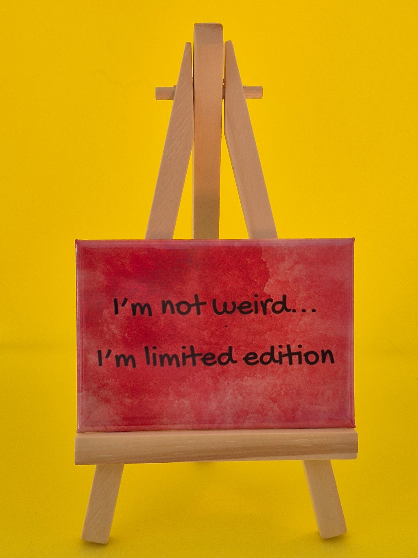 Red magnet with 'I'm not weird... I'm limited edition' text on a yellow background